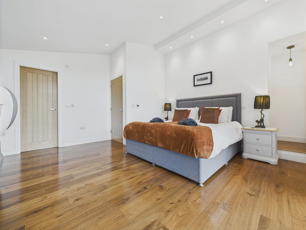 A bedroom with a bed and bedside tables at Oakwood House in Tansley near Matlock