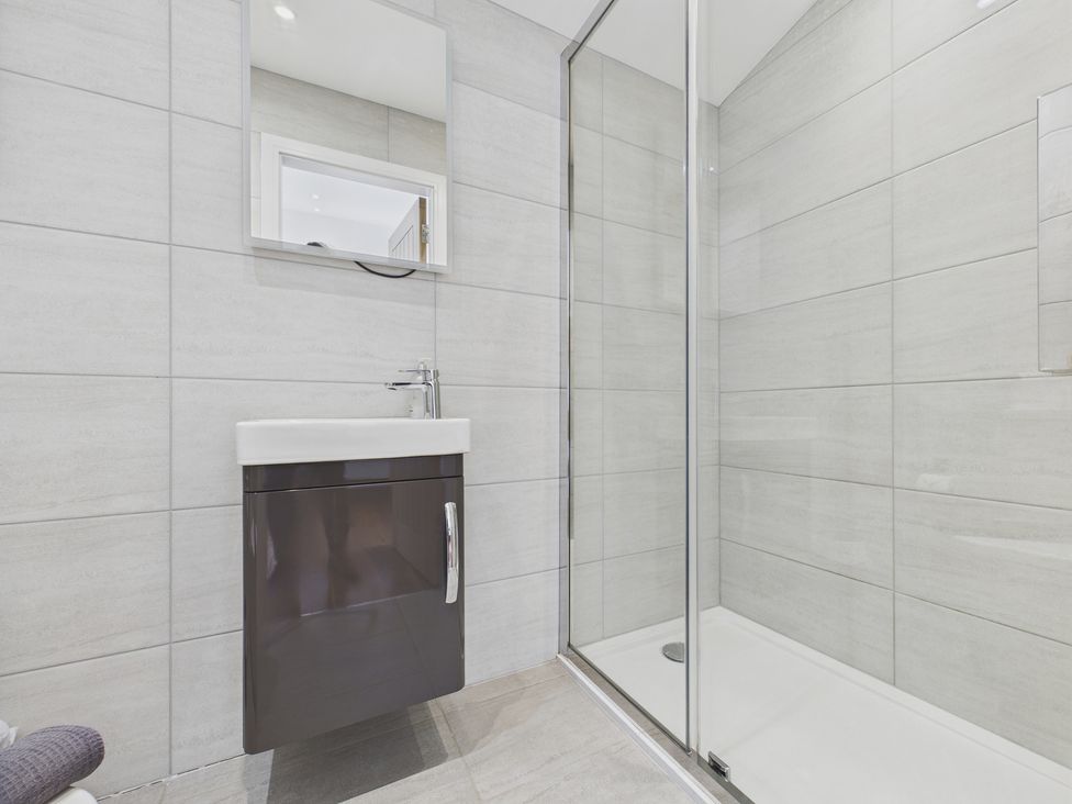 A bathroom with a sink and shower at Oakwood House Tansley near Matlock