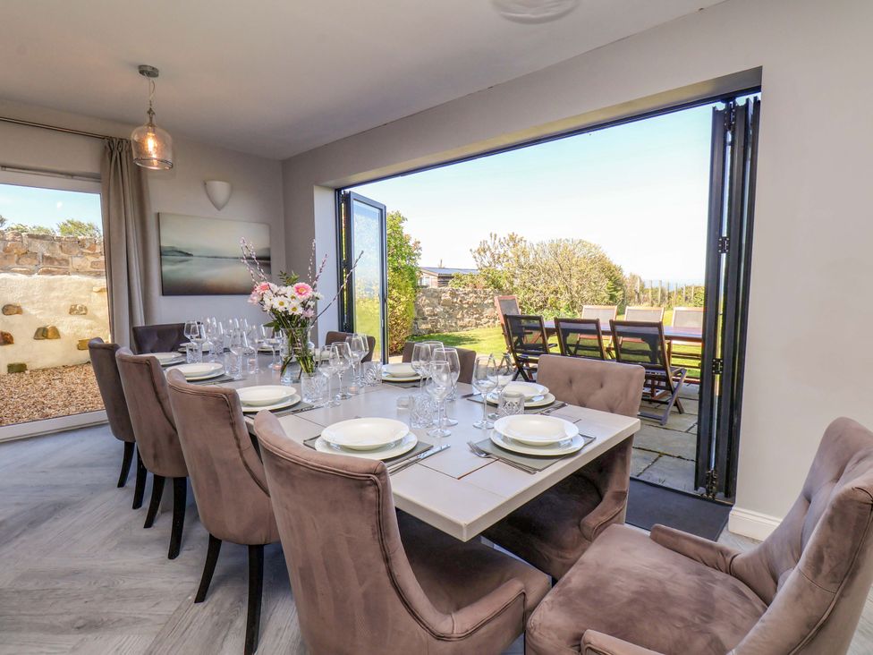 A dining room with a table set for dinner at Voebroch in Lythe