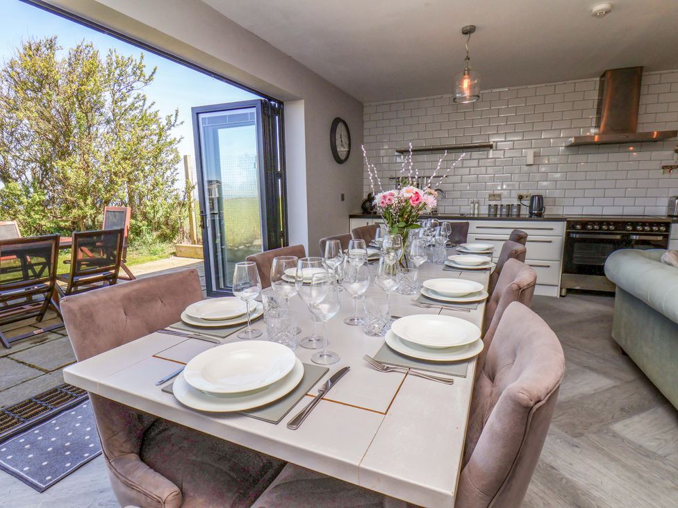 A dining room with a table set for a meal at Voebroch in Lythe