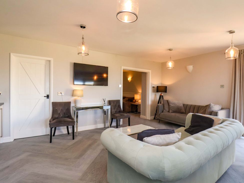 A living room with a television and seating at Voebroch in Lythe