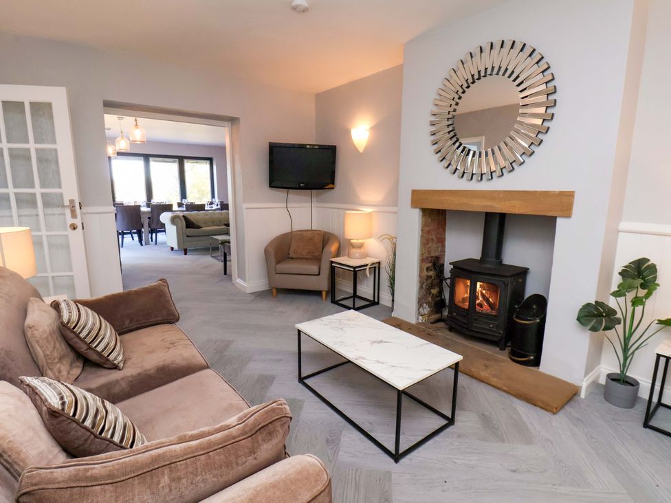A living room with a sofa and fireplace at Voebroch in Lythe