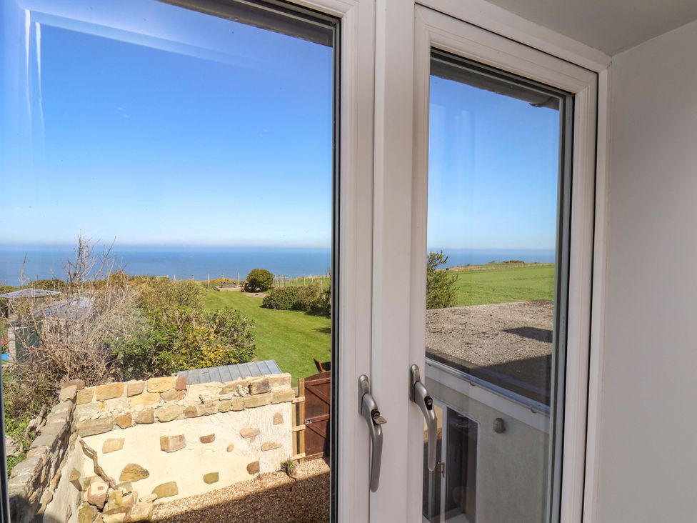 A view from a window showing the sea and garden at Voebroch in Lythe