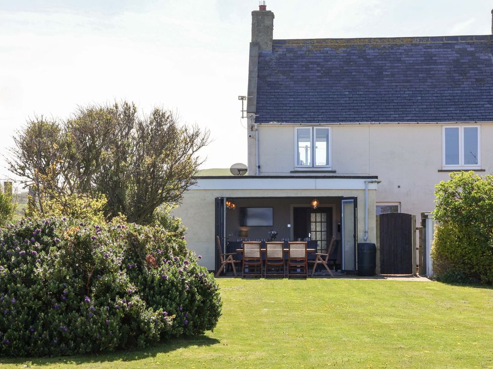 A house with a garden and outdoor dining area at Voebroch in Lythe