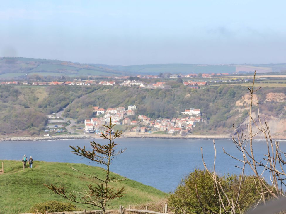 A scenic view of a coastline and a town overlooking the sea at Voebroch in Lythe