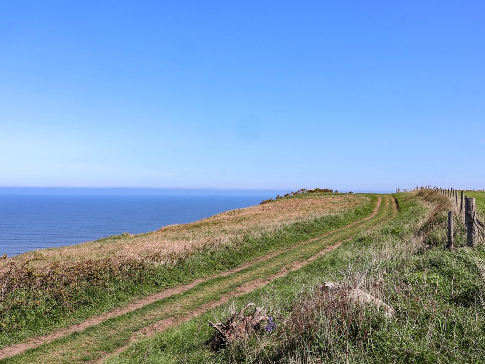 A pathway leading to the ocean with a fence at Voebroch in Lythe