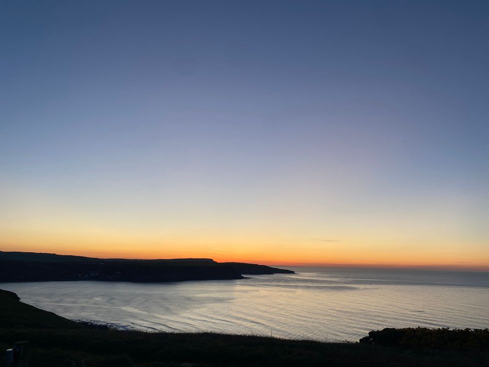 A sunset over the sea and coastline at Voebroch in Lythe