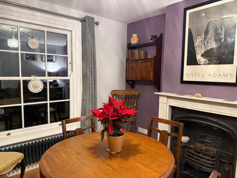 A dining room with a table and chairs at Overchurch in Hythe