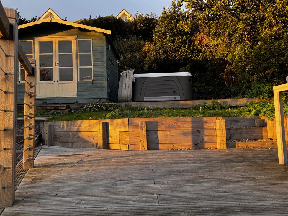 A garden with a shed and hot tub at Overchurch in Hythe