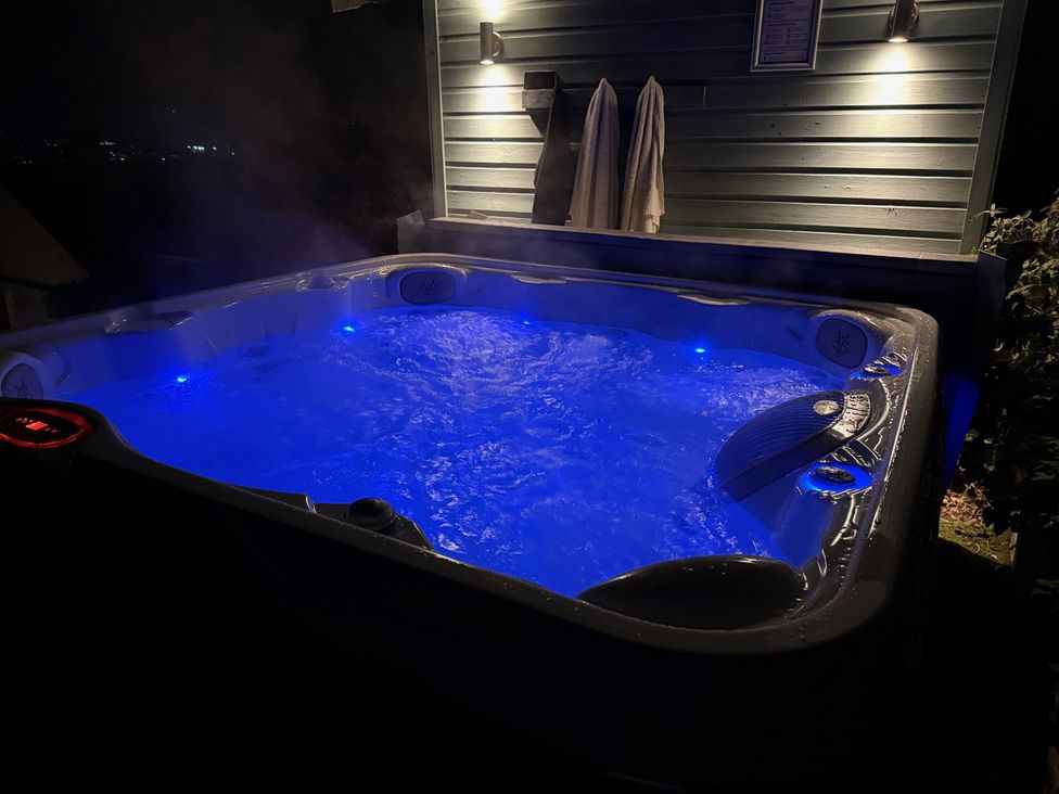 A hot tub with blue lights and towels at Overchurch in Hythe