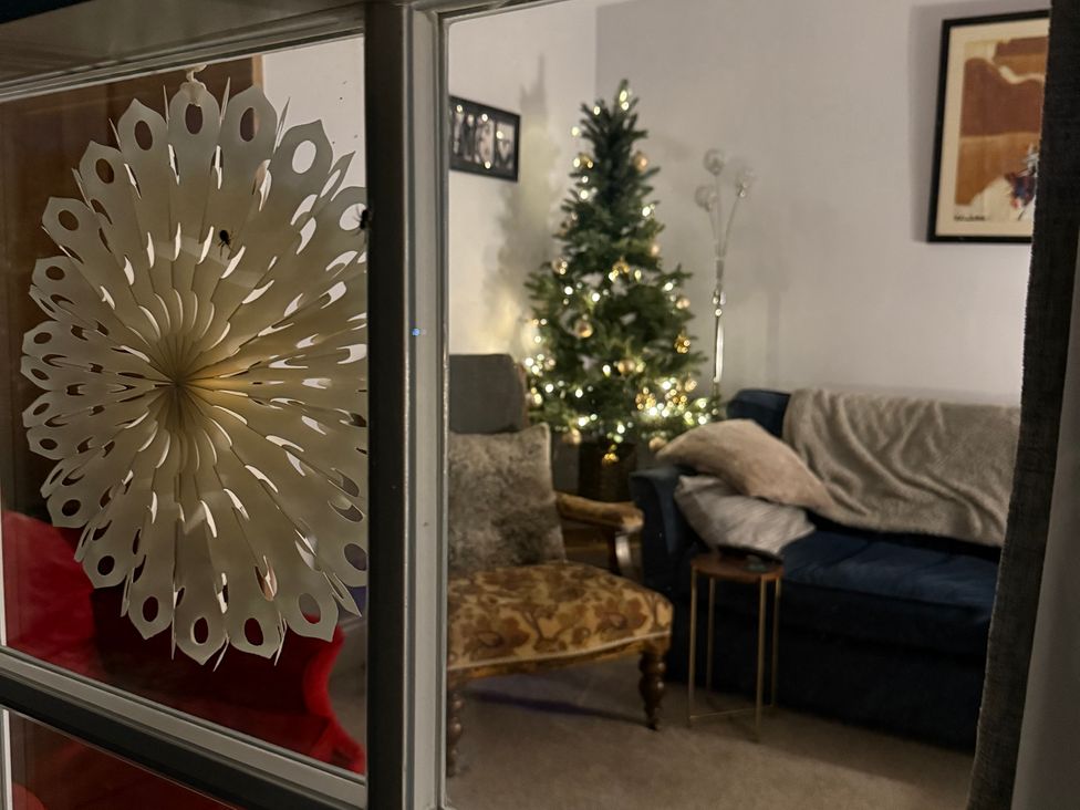 A living room with a Christmas tree and sofa at Overchurch in Hythe