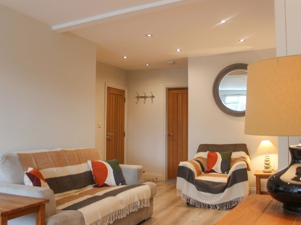 A living room with a sofa and armchair at Simples in Dartmouth