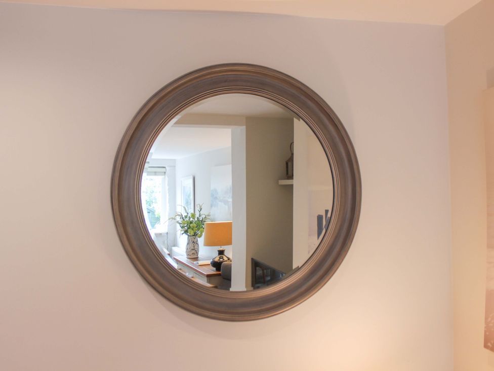 A mirror reflecting a living room at Simples in Dartmouth