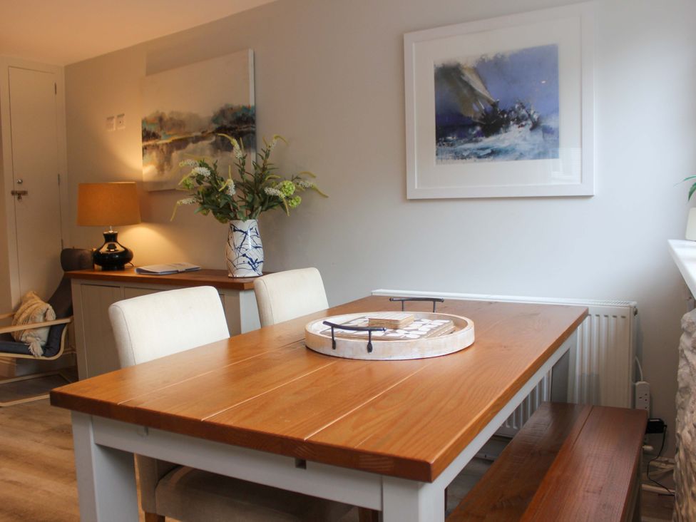 A dining area with a wooden table and chairs at Simples in Dartmouth