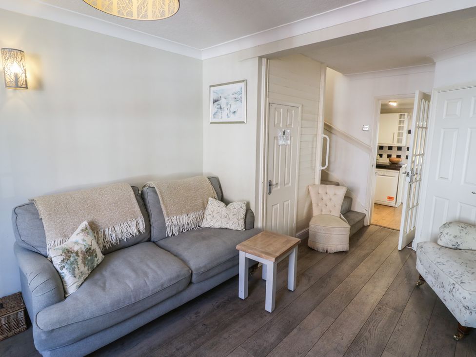 A living room with a sofa and coffee table at Heath Cottage in Stratford-Upon-Avon
