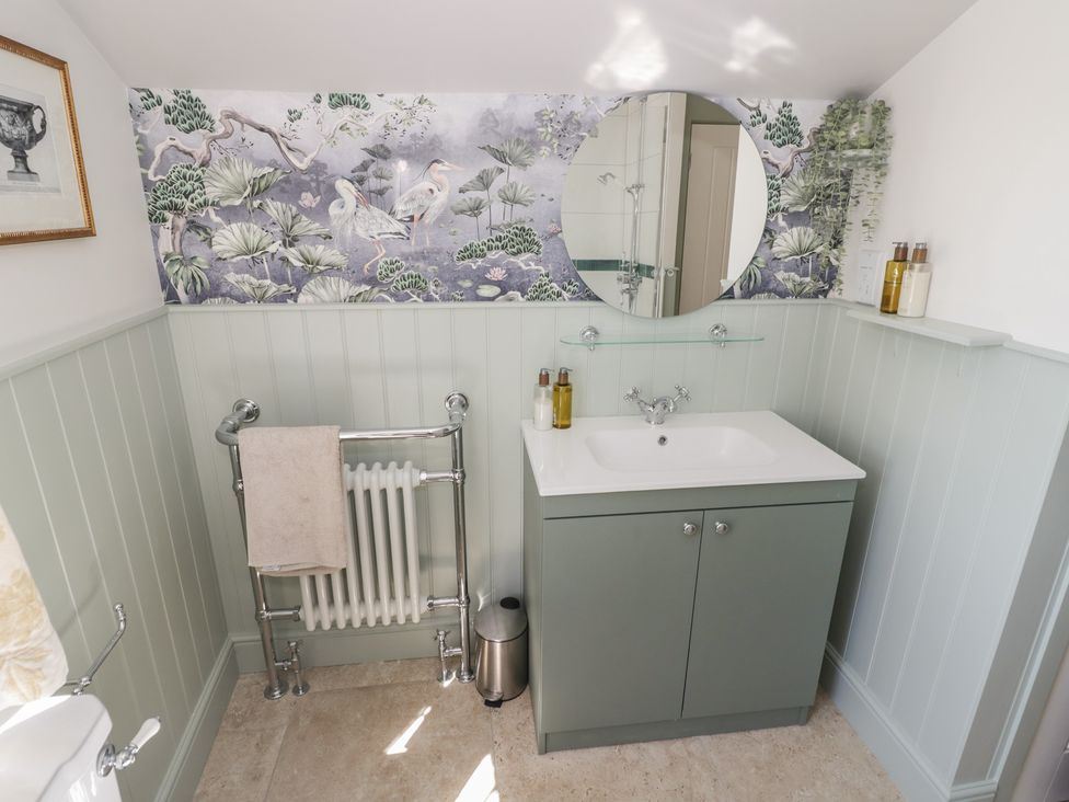 A bathroom with a mirror and sink at Heath Cottage Stratford-Upon-Avon
