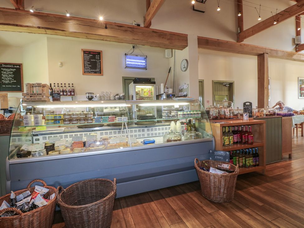 A café interior with a display case and seating at Sunny Cottage in Grantham