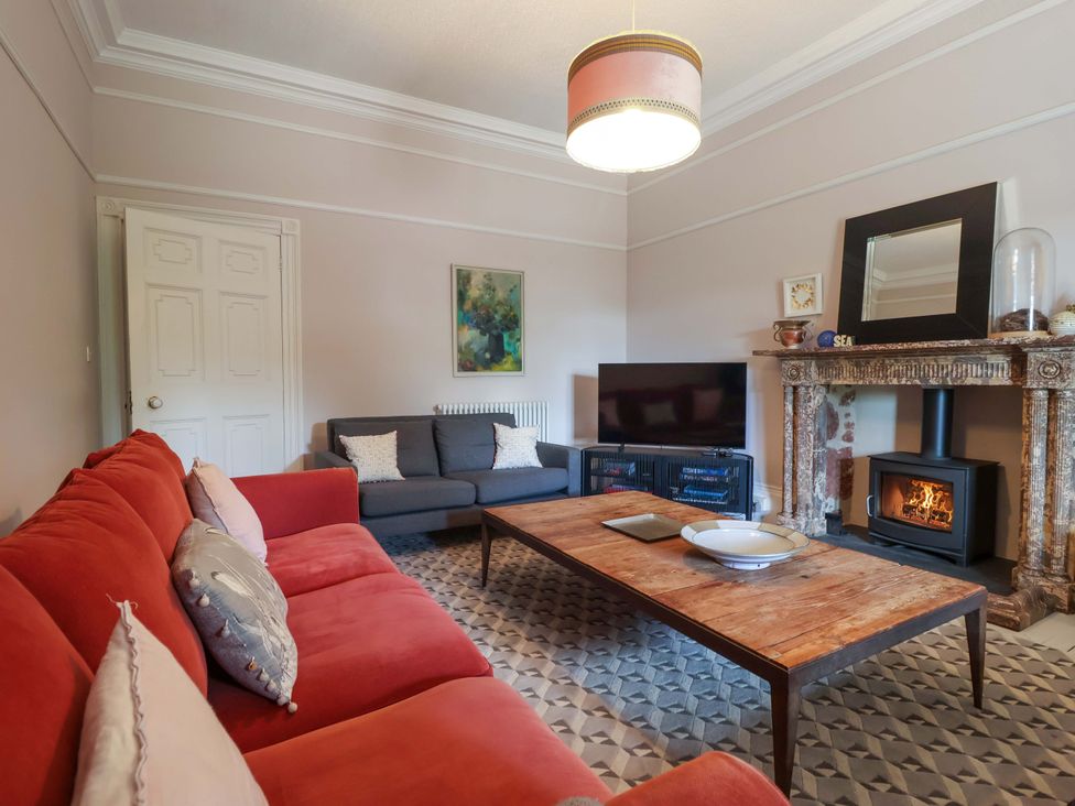 A living room with a sofa and coffee table at Barnsley House in Teignmouth