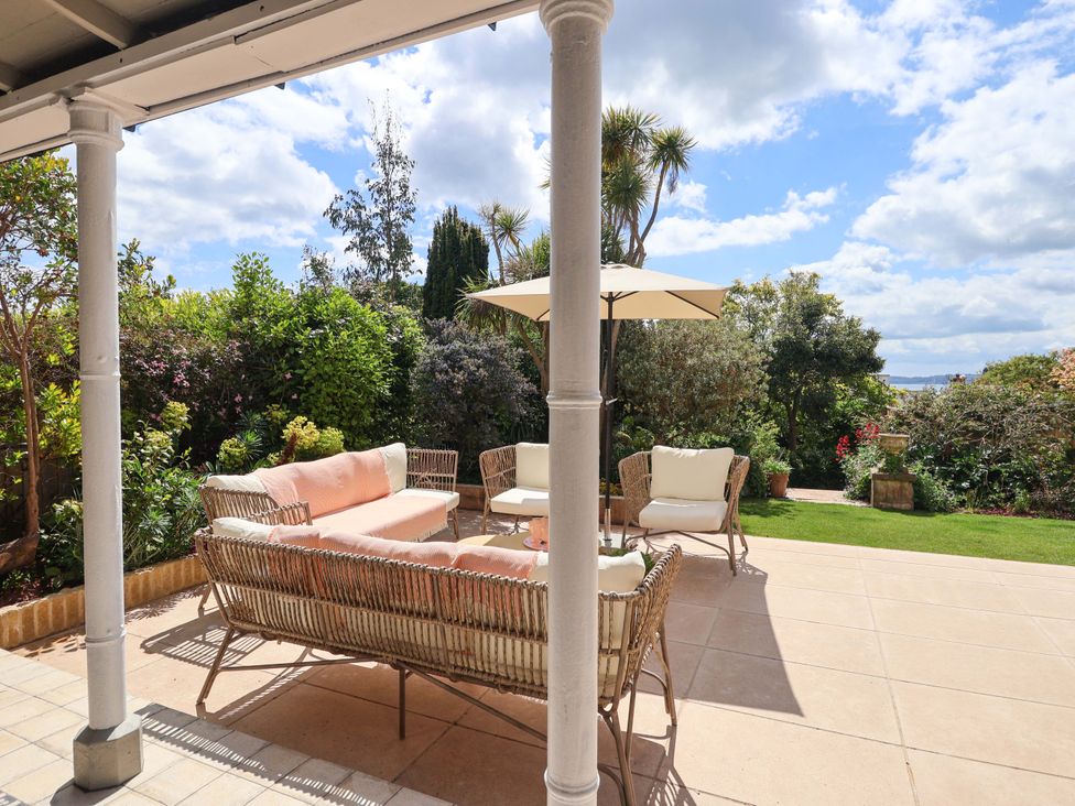 An outdoor seating area with a sofa and table at Barnsley House in Teignmouth