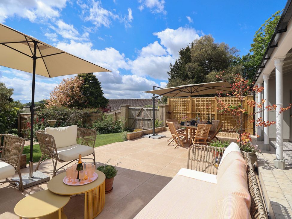 A garden with outdoor seating and dining area at Barnsley House in Teignmouth