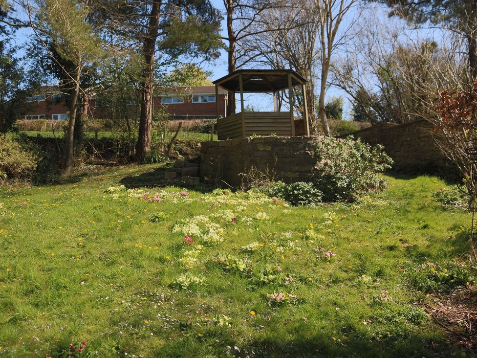 A garden with a gazebo and flowers at The Old Bakery in South Perrott near Mosterton