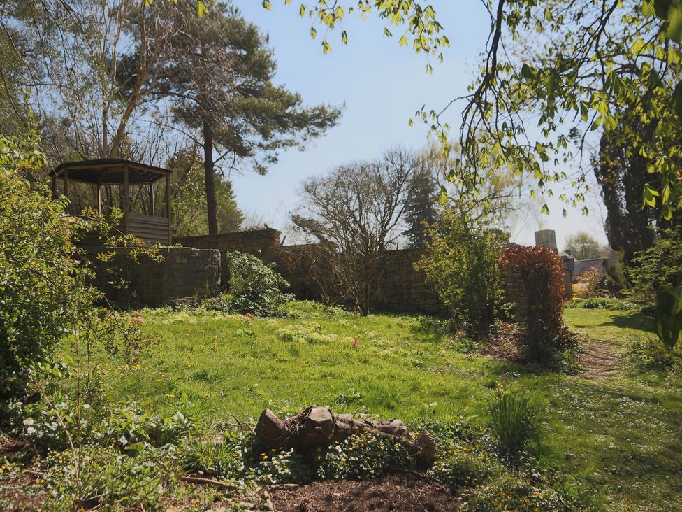 A garden with trees and a shed at The Old Bakery in South Perrott near Mosterton