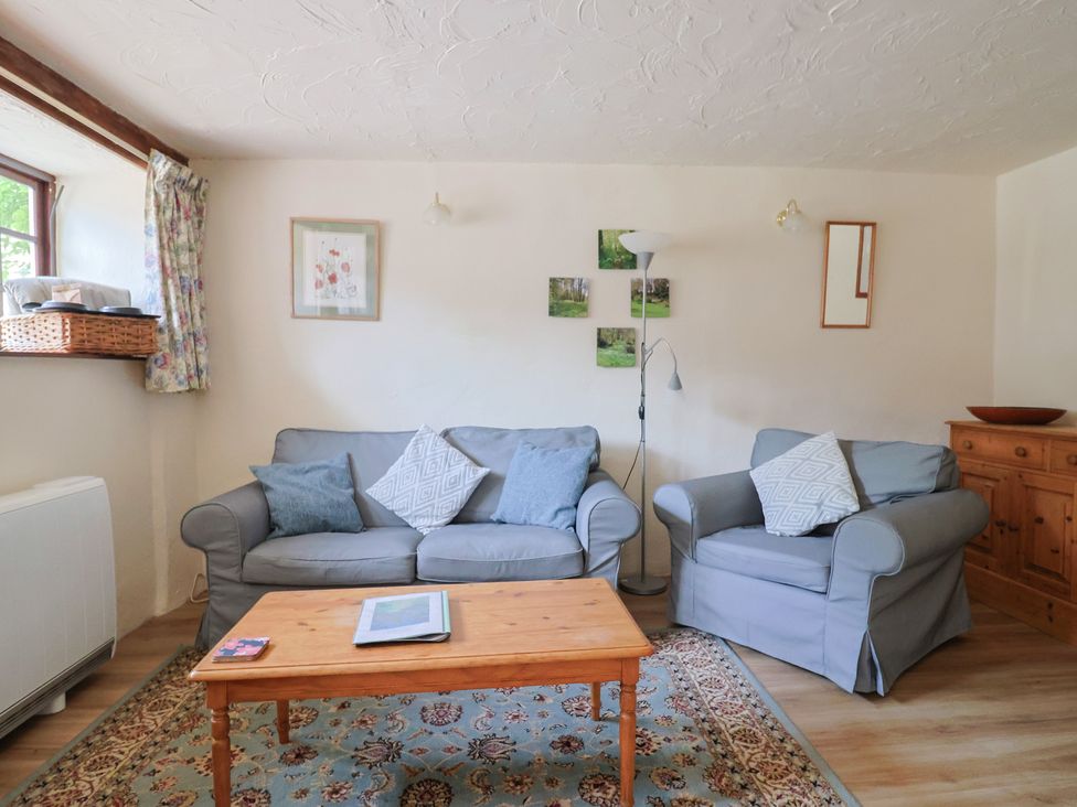 A living room with a sofa and coffee table at The Old Bakery in South Perrott near Mosterton