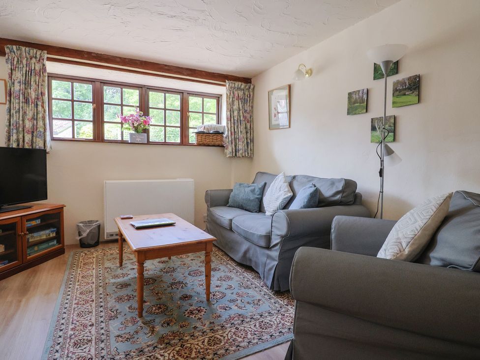 A living room with a sofa and coffee table at The Old Bakery in South Perrott near Mosterton