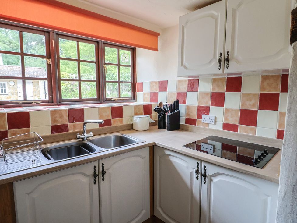 A kitchen with sink and cooking hob at The Old Bakery South Perrott near Mosterton