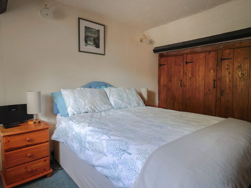 A bedroom with a bed and a bedside table at The Old Bakery in South Perrott near Mosterton