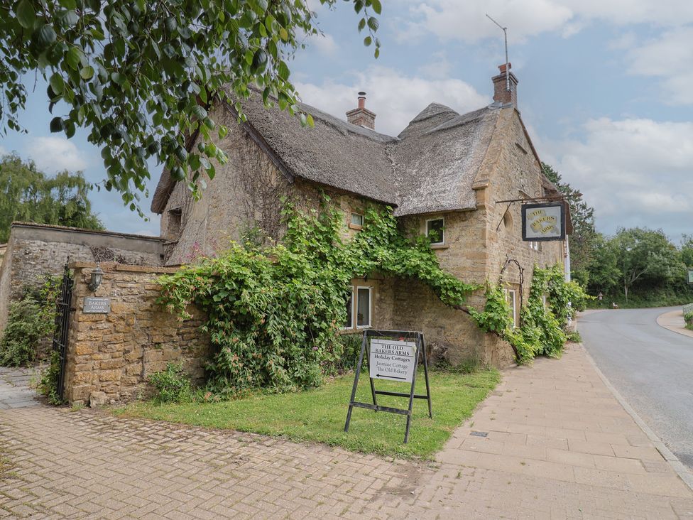 A traditional stone building with signage at The Old Bakery in South Perrott near Mosterton