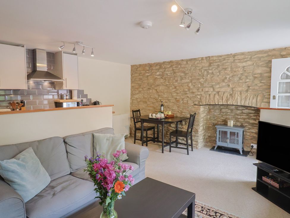 A living room with a sofa and dining table at Jasmine Cottage South Perrott near Mosterton