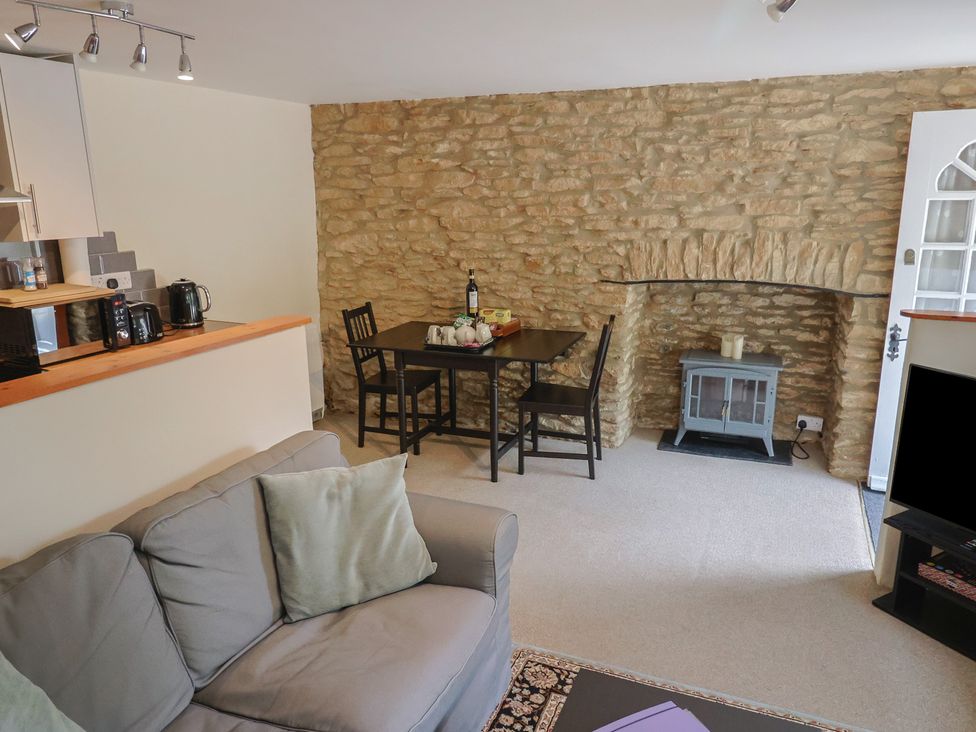 A living room with a dining table and a sofa at Jasmine Cottage South Perrott near Mosterton