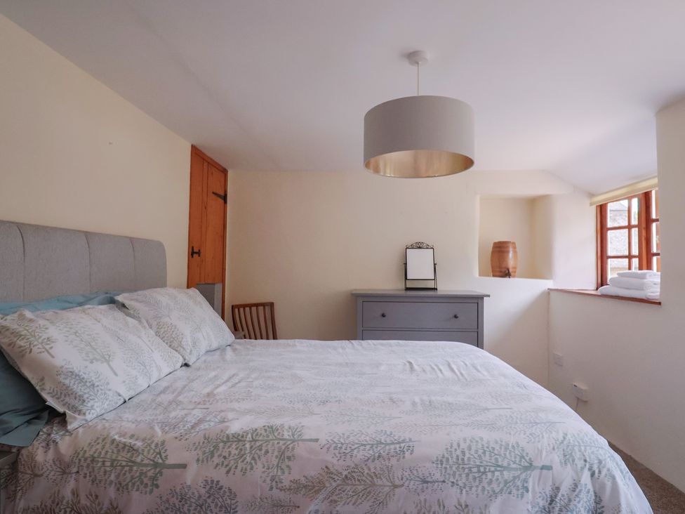 A bedroom with a bed and a drawer unit at Jasmine Cottage South Perrott near Mosterton