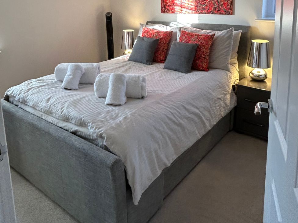 A bedroom with a bed and bedside tables at The Green in Whitby