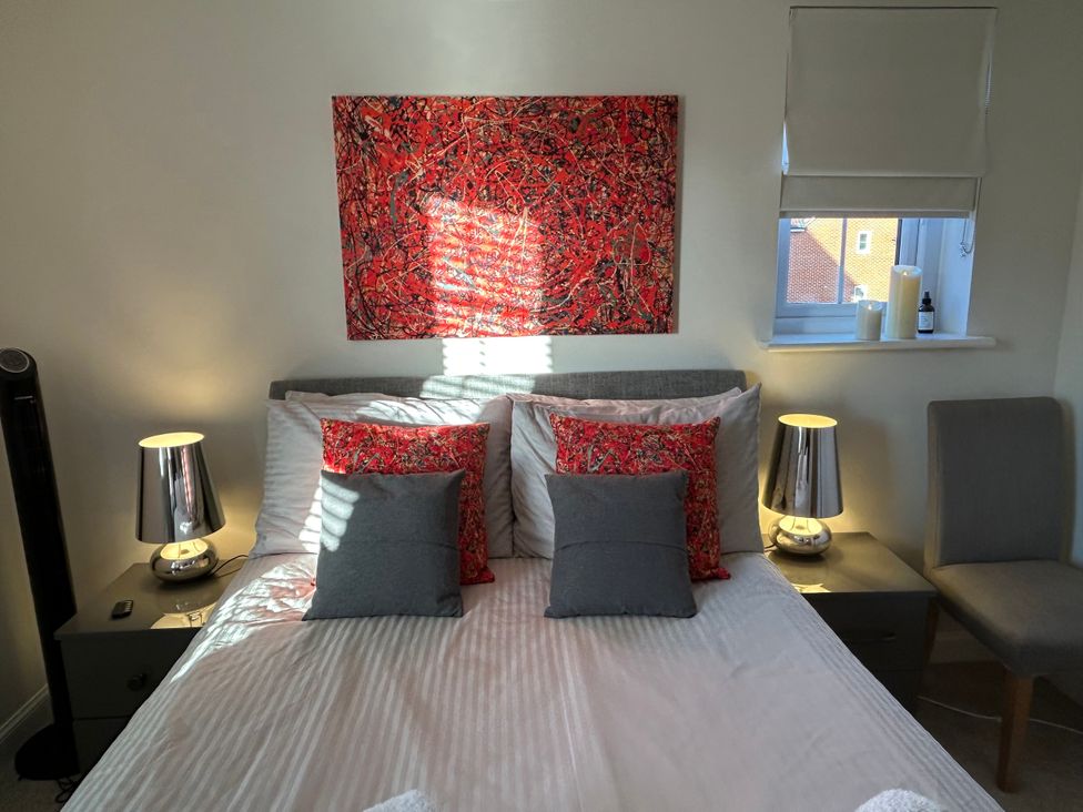 A bedroom with a bed and lamps at The Green in Whitby