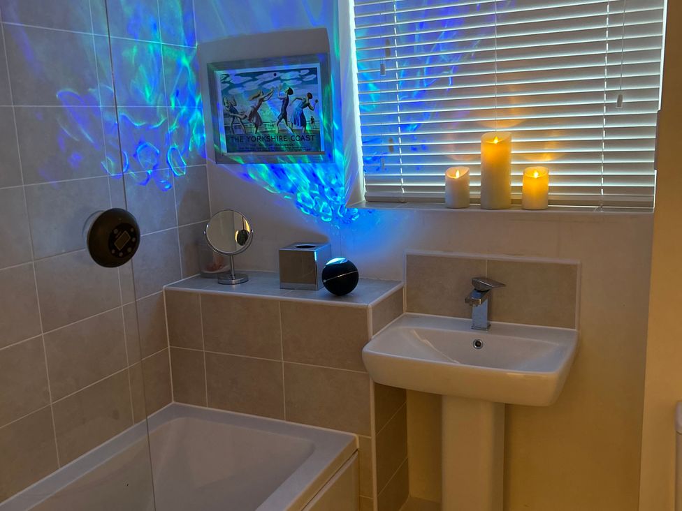 A bathroom with a bath tub and sink at The Green in Whitby