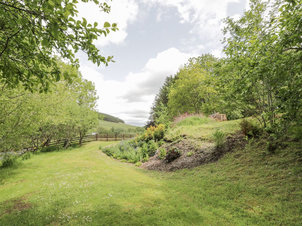 A garden with trees and flowers at Torview House Lyne Station near Peebles