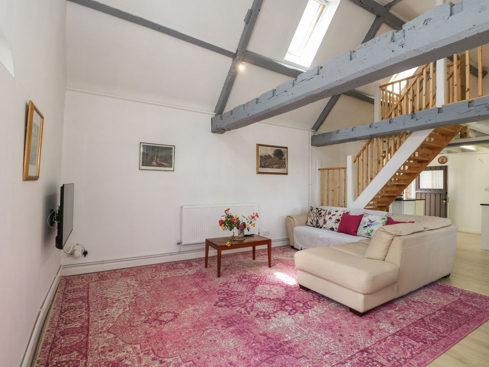 A living room with a sofa and coffee table at Coach House Swindon