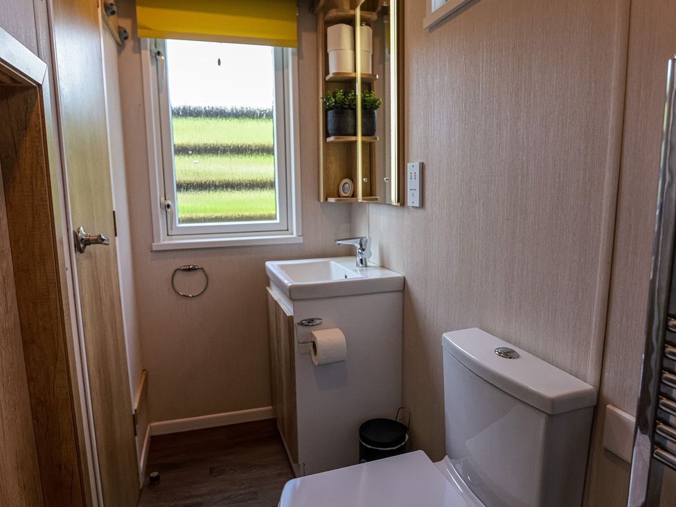 A bathroom with a sink and toilet at The Fox Den Nantmel near Rhayader