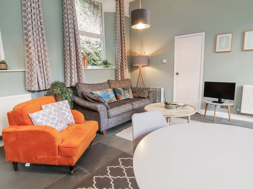 A living room with a sofa, armchair, and coffee table at Ferndale in Lynton