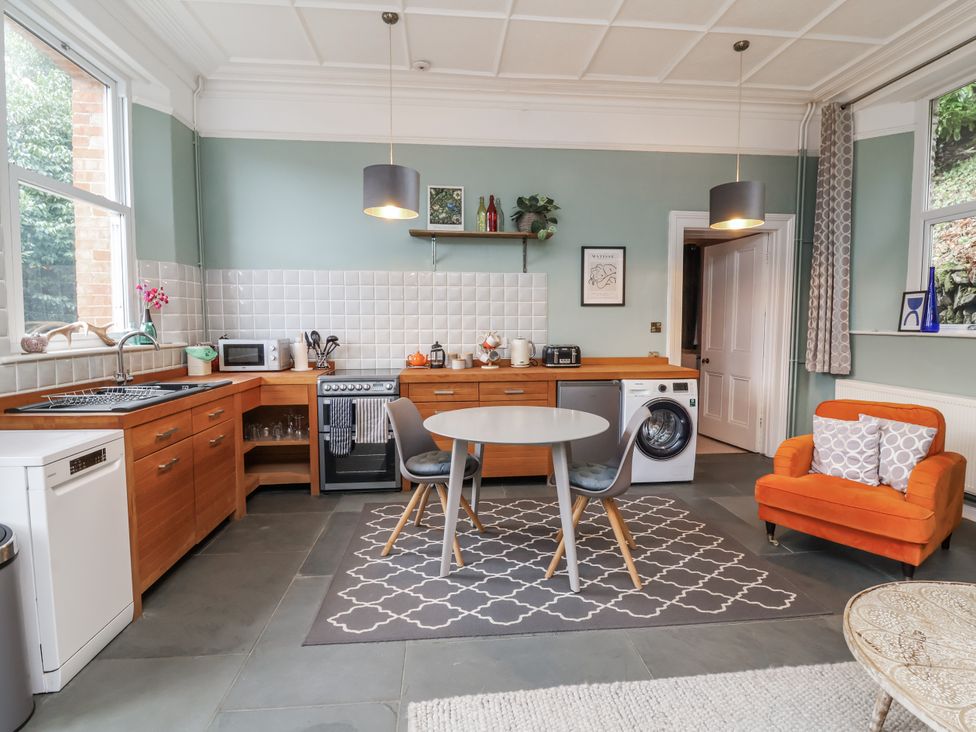 A kitchen with appliances and a dining table at Ferndale in Lynton