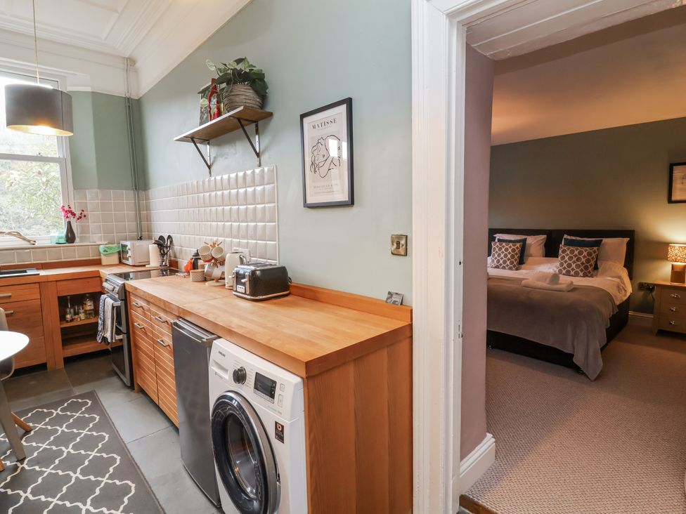 A kitchen with a washing machine and a countertop at Ferndale in Lynton