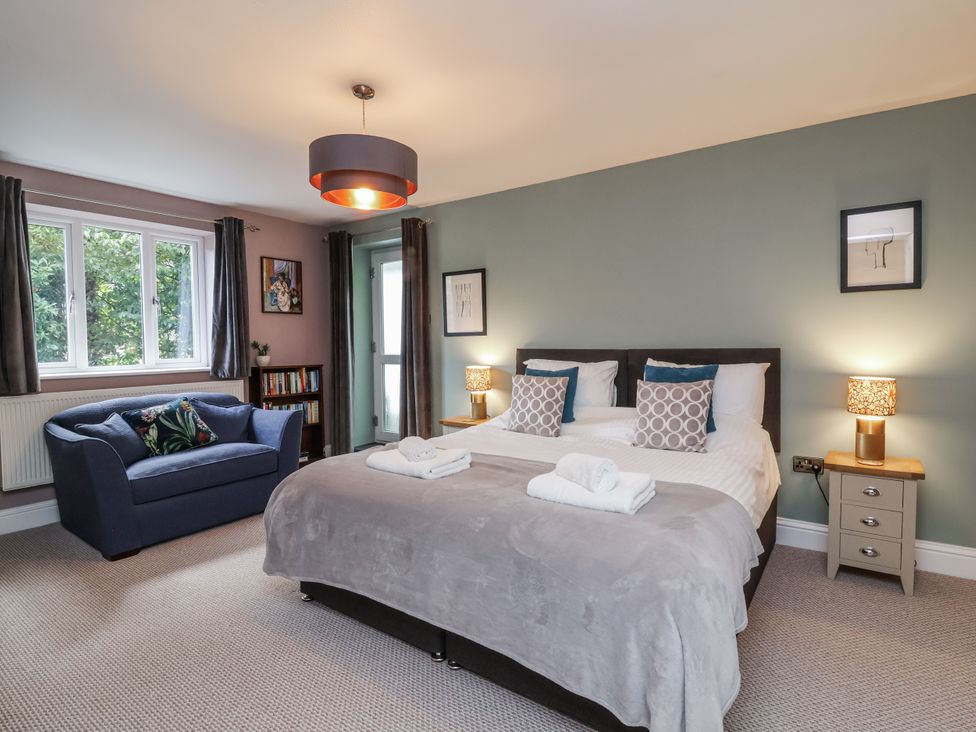 A bedroom with a bed and a sofa at Ferndale in Lynton