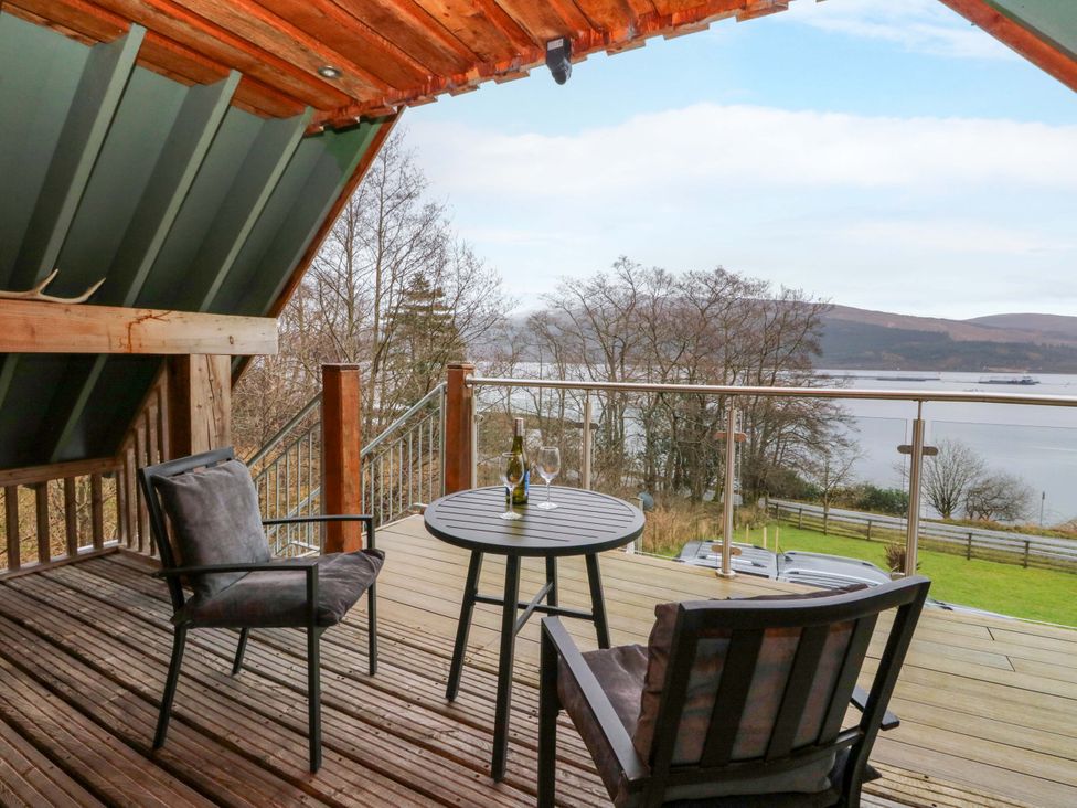 An outdoor patio with a table and chairs at The Apartment in Ardgour