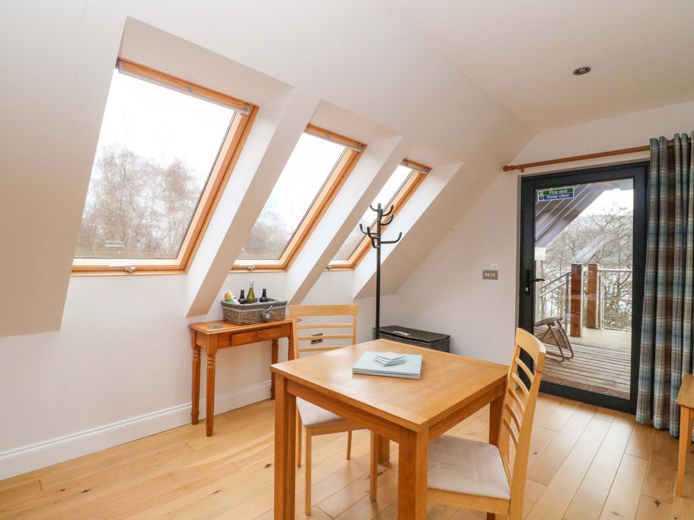 A dining room with a table and chairs at The Apartment in Ardgour