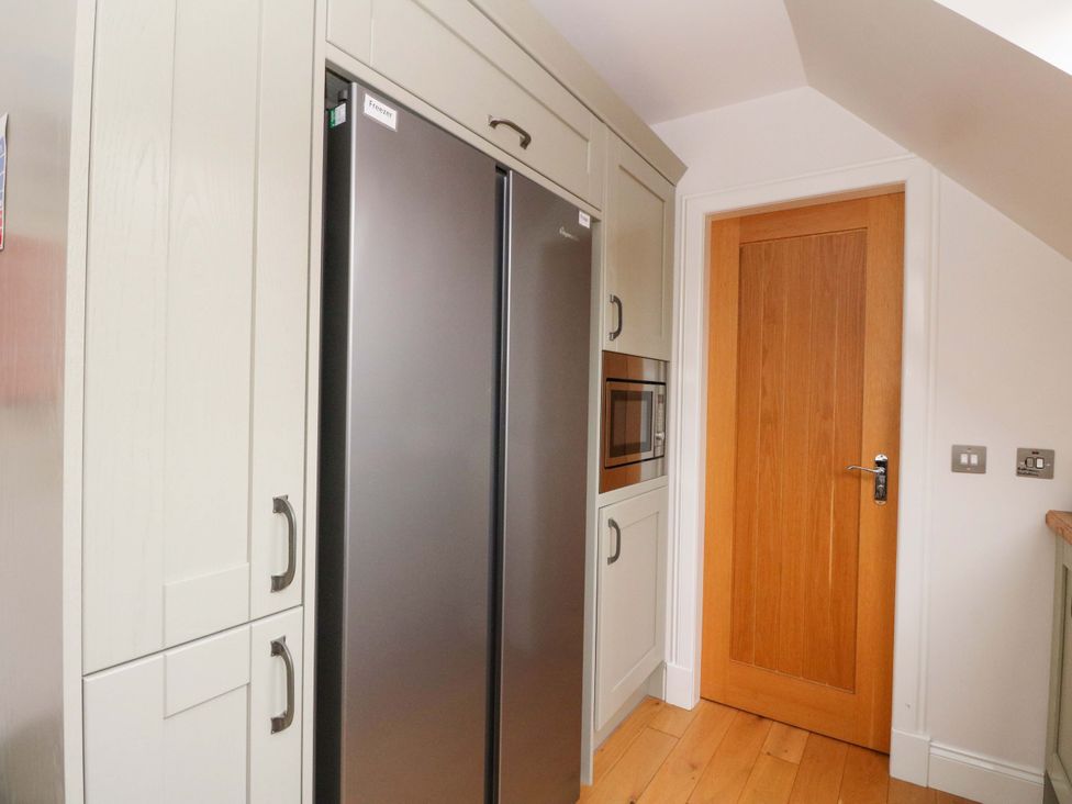 A kitchen with refrigerator and microwave at The Apartment in Ardgour