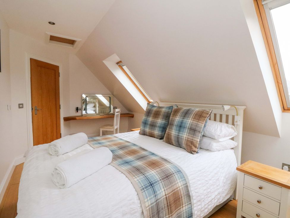 A bedroom with a bed and desk at The Apartment in Ardgour