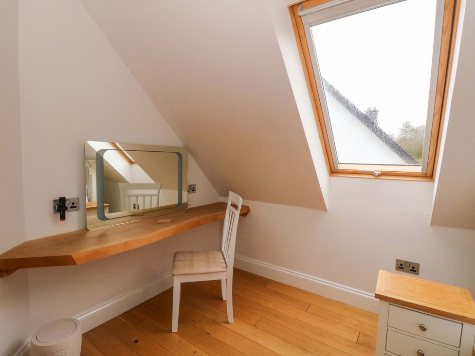 A workspace with a desk and chair under a window in The Apartment Ardgour