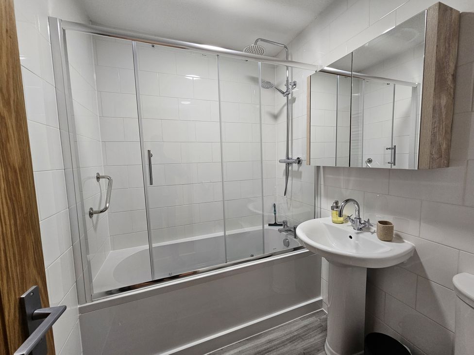 A bathroom with a bathtub and shower at Seashells Cottage Lytham St. Annes